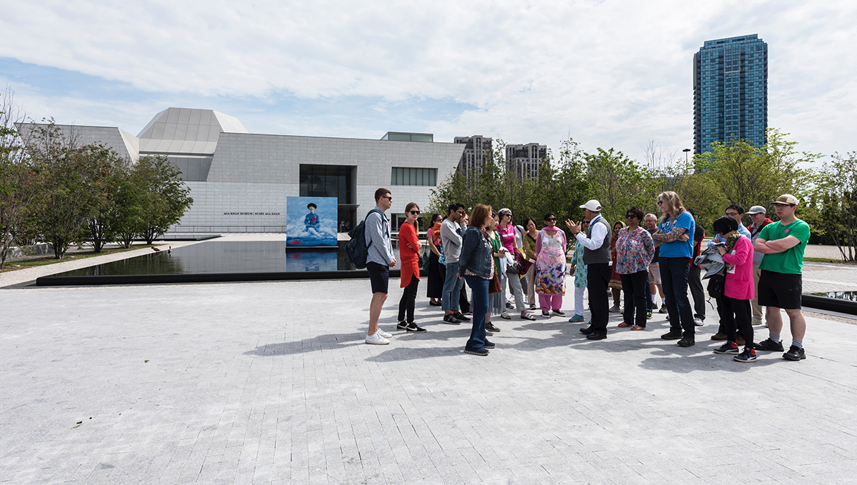 A volunteer leads a group of about 20 people on a tour of the Aga Khan Park at the Aga Khan Museum in Toronto.